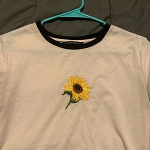 WHITE TOO WITH BLACK LINING SUNFLOWER ON IT.